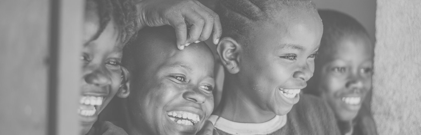 Four happy children smiling wide.